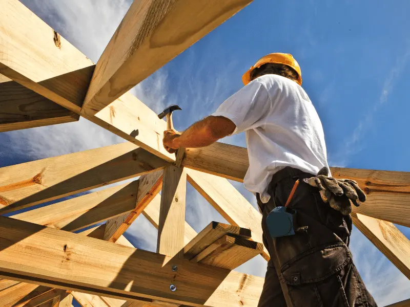 man doing construction with wood